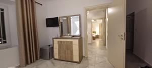 a bathroom with a vanity and a mirror in a room at Hyka Stone House Shkoder in Shkodër
