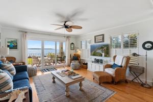 a living room with a blue couch and a table at Pier Pointe #101 - 100 Floyd Street, Unit 101 in Saint Simons Island
