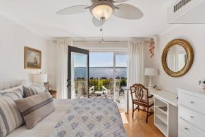 a bedroom with a bed and a desk with a table at Pier Pointe #101 - 100 Floyd Street, Unit 101 in Saint Simons Island