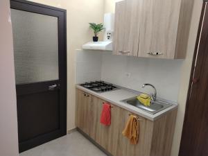 a small kitchen with a sink and a stove at Sicilian Room in Catania