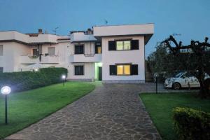 a house with a car parked in front of it at Al Tredici in Ardea