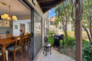 a screened in porch with a table and a grill at Harbour Oaks, Unit 419 in Saint Simons Island
