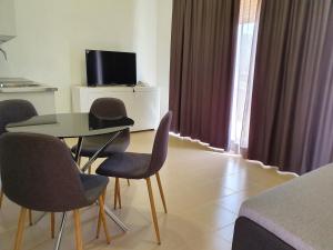 a room with a table and chairs and a television at Camino De Rabe in Rabé de las Calzadas
