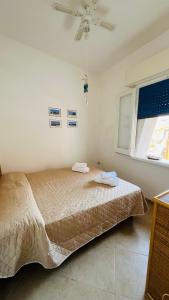 a bedroom with a bed with two towels on it at Mare Infinito in Pantelleria +23 photos
