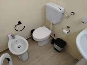 a bathroom with a toilet and a sink at Sicilian Room in Catania +26 photos