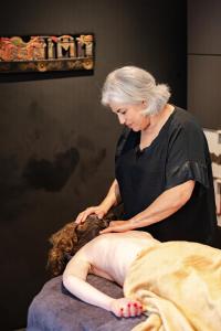 a woman is sitting on top of a massage at Villa Plagniau in Rixensart