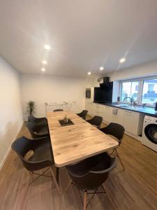 a wooden table and chairs in a kitchen at Casita 2 in Essenbach