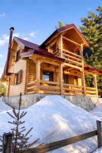 a log cabin in the winter with snow at Guest house Mickovic in Žabljak
