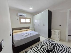 a bedroom with a bed and a zebraebra rug at casabianca north coast villa code 112 in Dawwār Muḩammad Abū Shanab +46 photos