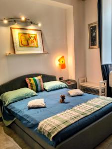 a bedroom with two beds with a dog laying on the bed at Resta Con Me in Genoa