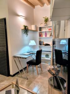 a room with a table and chairs and a book shelf at Resta Con Me in Genoa