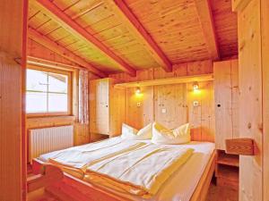 a bedroom with a bed in a wooden cabin at Chalet mit Sauna und Kamin A 257.001 in Stumm