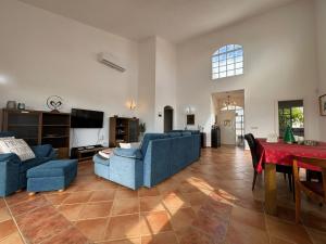 a living room with two blue couches and a table at Casa Alegria in Puerto Rico de Gran Canaria
