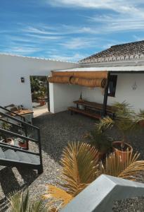 a white house with a patio with plants at Boutique B&B Finca Viva la Vida in Alora