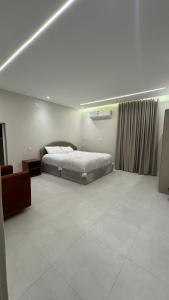 a bedroom with a bed and a television in it at سويت بغرفتين نوم in Al Majaridah