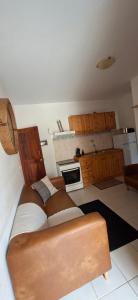 a kitchen with a couch in the middle of a room at Carla Tryana Fernandes Castro in Vila do Porto