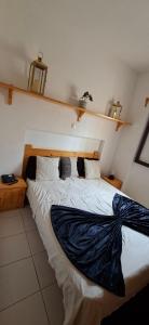 a bedroom with a large bed with a blanket on it at Carla Tryana Fernandes Castro in Vila do Porto