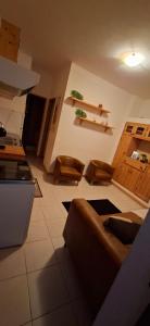 a living room with a couch and a kitchen at Carla Tryana Fernandes Castro in Vila do Porto +2 photos