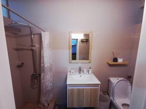 a bathroom with a sink and a toilet and a mirror at Sam & Chlo Studio & Appartment - Grand Baie - Mauritius in Grand-Baie