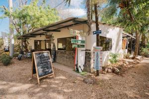 a small building with signs in front of it at Avellanas Surf Hostel in Playa Avellana