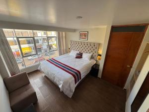 a bedroom with a large bed and a window at Hotel Inka House Chinchero in Chincheros