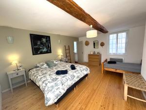 a bedroom with a bed and a wooden floor at La Halte de la Hunière - Jardin - Central - Garage in Vimoutiers