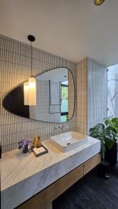 a bathroom with a sink and a mirror at The Bataran Cabin in Gitgit +20 photos