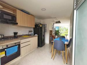a kitchen with a table and a blue counter top at Hospedaje en Montenegro Vivienda Turística Cafecito in Montenegro +20 photos