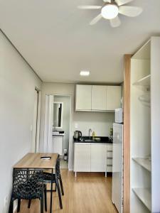 a kitchen with a table and a dining room at Studio Garten Container in Joinville