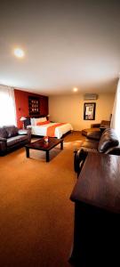 a hotel room with a bed and a couch at La Huerta golf & hotel in Cholula
