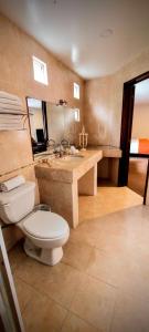 a bathroom with a toilet and a sink at La Huerta golf & hotel in Cholula +20 photos