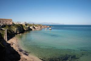 a view of a beach with boats in the water at IVAN house - TERRASINI SICILIA in Terrasini