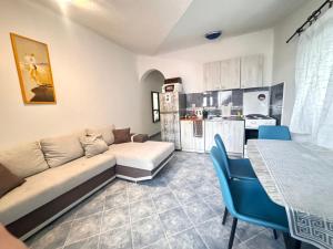 a living room with a couch and a table and a kitchen at Bay Mola Aparts in Kotor