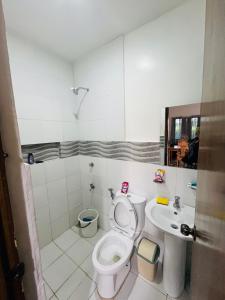a bathroom with a toilet and a sink at Akina 2bedroom Transient House in Kabankalan