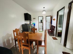 a dining room and living room with a table and chairs at Akina 2bedroom Transient House in Kabankalan