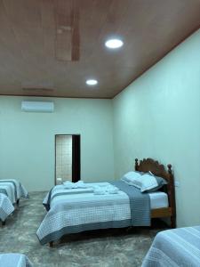 a bedroom with two beds in a room at Hospedaje Alejandra in Canoas +3 photos