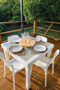 a white table and chairs on a deck at Kaloukera in Trois-Rivières