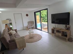 a living room with a couch and a flat screen tv at Kaloukera in Trois-Rivières