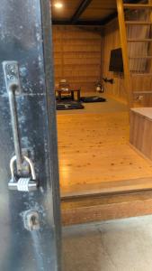 a door with a latch on a room with a wooden floor at くまの蔵 Kumanokura inn Storehouse in Shingū