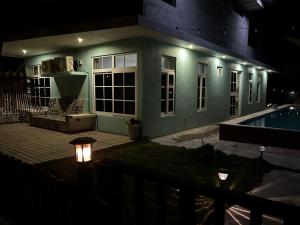 a house with a swimming pool at night at La casa de Fercho in Sipacate +1 photo