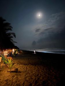 a person standing on the beach at night at La casa de Fercho in Sipacate