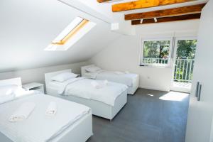 a white room with two beds and a window at Villa-Vista di Pini Sarajevo in Sarajevo +51 photos