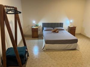 a bedroom with a bed and two night stands at Mango Home - Casa privada con pileta in Puerto Iguazú