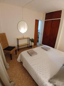 a bedroom with a bed and a table and a lamp at Casa Serena in Munro