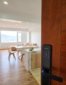 a remote control in a living room with a table and chairs at Cusco Nest in Cusco