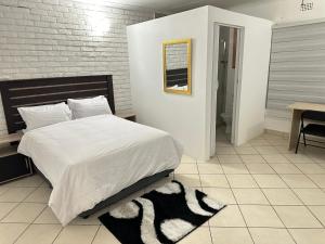 a bedroom with a large bed and a table and a desk at Eagle Empire in Vereeniging