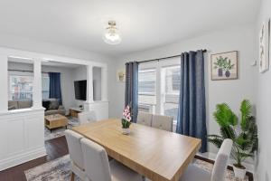 a dining room with a wooden table and chairs at Modern Niagara Loft with Private Sunset Balcony Duplex in Niagara Falls
