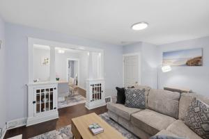 a living room with a couch and a table at Modern Niagara Loft with Private Sunset Balcony Duplex in Niagara Falls