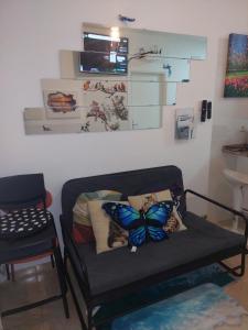 a living room with a couch with butterfly pillows at Ketchs House in Ponte de Sor