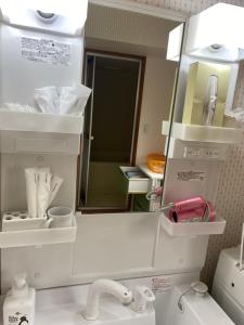 a bathroom with a sink with a mirror and a sink at Shiro の秘密基地 駐車場無料 in Ōmagari +38 photos